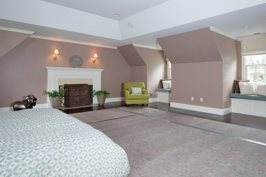 23 Pembroke Road Wellesley, MA 02482 - Photo 10 of 16 a bedroom with a bed and a fireplace