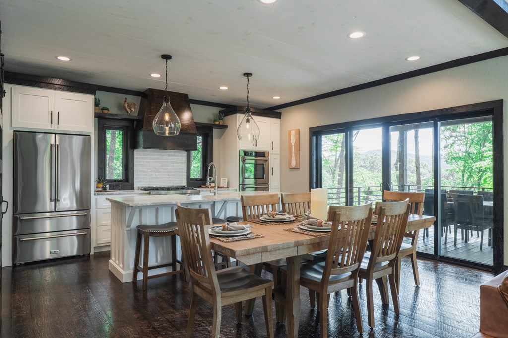 741 Price Road Blue Ridge, GA 30513 - Photo 11 of 58 a kitchen with kitchen island a large window and stainless steel appliances