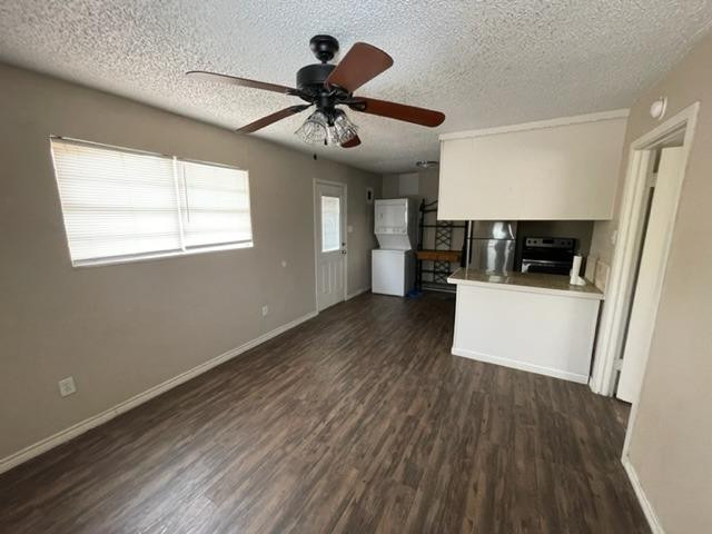 4119 32nd Street, Unit REAR Lubbock, TX 79410 - Photo 2 of 9 a view of a room with wooden floor a ceiling fan and windows