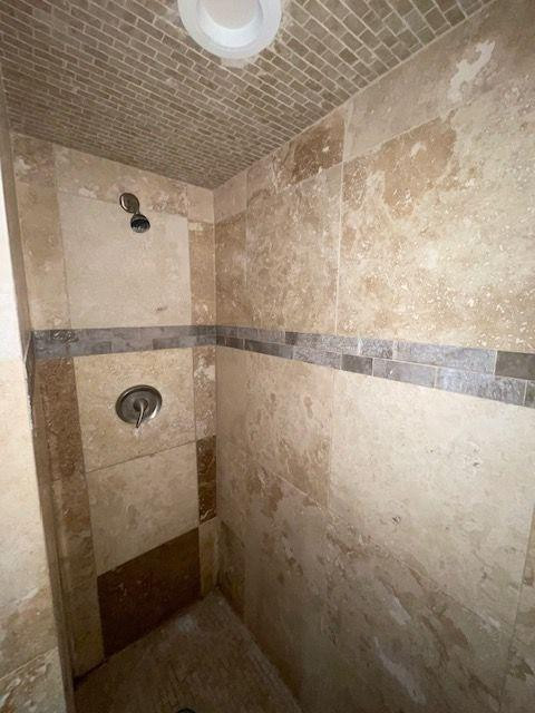 4119 32nd Street, Unit REAR Lubbock, TX 79410 - Photo 8 of 9 a bathroom with a granite countertop sink and a mirror