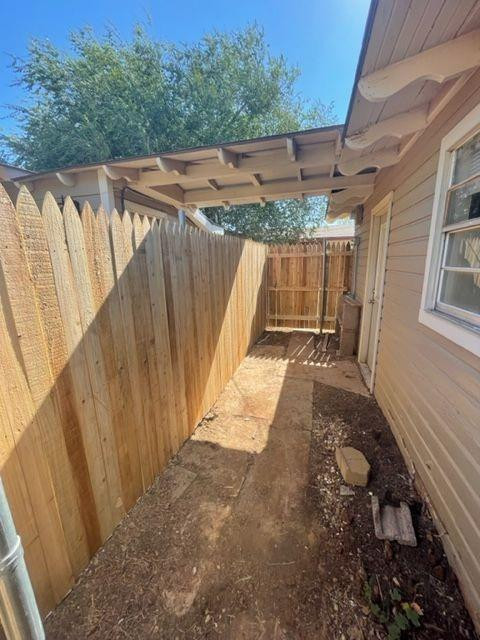 4119 32nd Street, Unit REAR Lubbock, TX 79410 - Photo 9 of 9 a view of a backyard with wooden fence