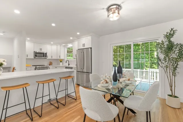 a view of a dining room with furniture a chandelier and wooden floor