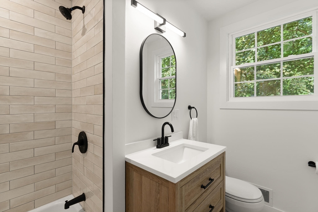 77 Morton Street Canton, MA 02021 - Photo 16 of 28 a bathroom with a sink toilet and a mirror