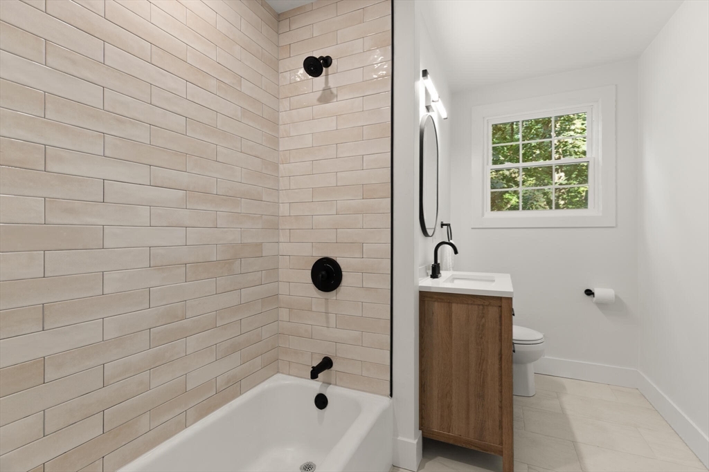 77 Morton Street Canton, MA 02021 - Photo 17 of 28 a bathroom with a bathtub and a shower