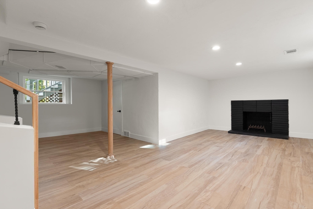 77 Morton Street Canton, MA 02021 - Photo 20 of 28 a view of an empty room with a fireplace and a window