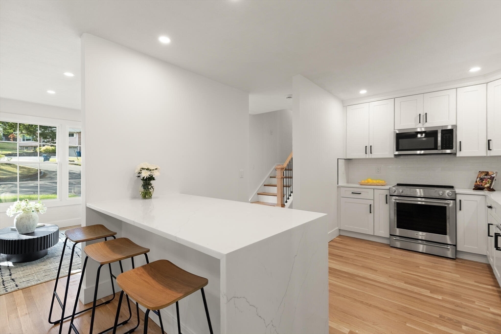 77 Morton Street Canton, MA 02021 - Photo 4 of 28 a kitchen with a stove a sink and a refrigerator