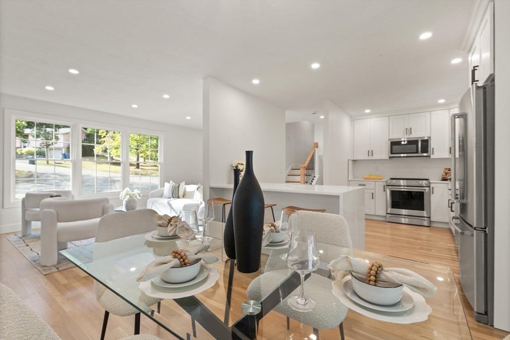 77 Morton Street Canton, MA 02021 - Photo 9 of 28 a kitchen with stainless steel appliances kitchen island granite countertop a kitchen island a stove a table and chairs