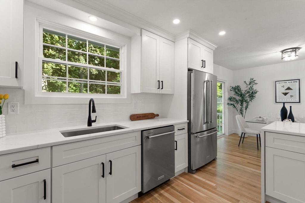 77 Morton Street Canton, MA 02021 - Photo 10 of 28 a kitchen with stainless steel appliances a refrigerator sink and wooden floor
