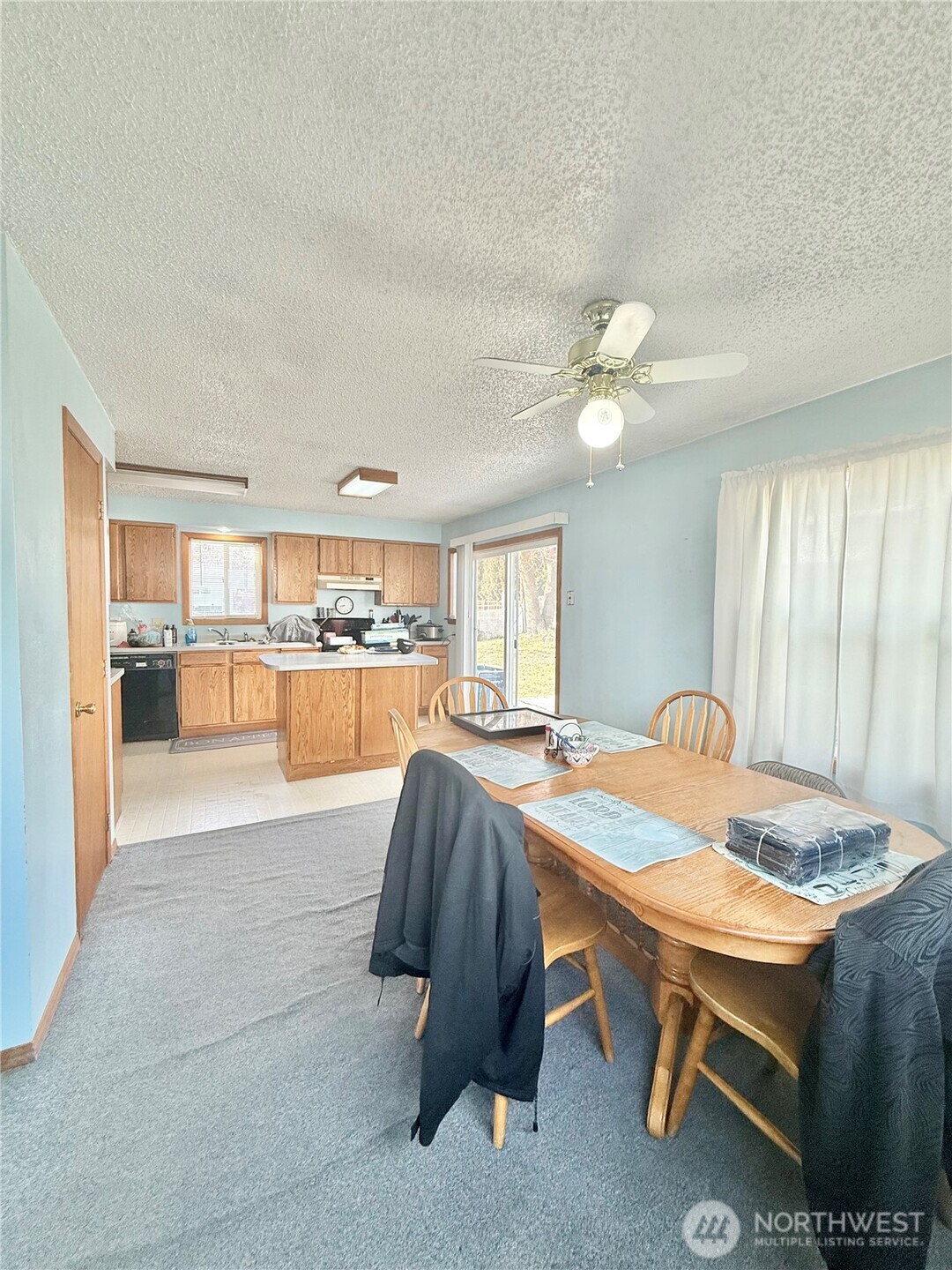 965 3rd Avenue North Okanogan, WA 98840 - Photo 14 of 26 a view of kitchen with kitchen island dining table and chairs