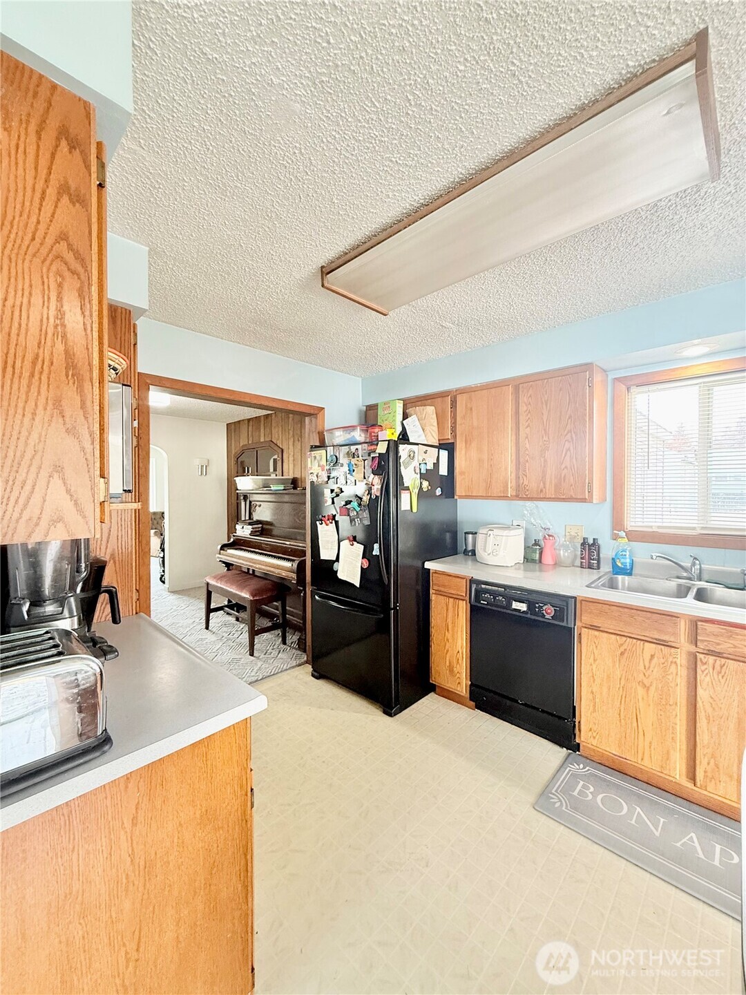 965 3rd Avenue North Okanogan, WA 98840 - Photo 15 of 26 a kitchen with stainless steel appliances kitchen island granite countertop a sink and counter top space