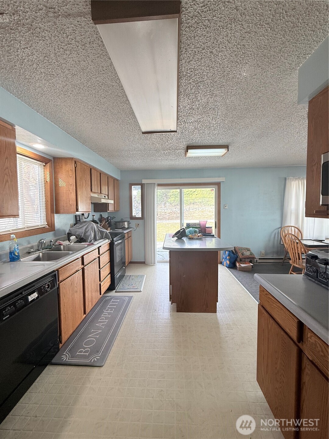 965 3rd Avenue North Okanogan, WA 98840 - Photo 16 of 26 a large kitchen with stainless steel appliances kitchen island granite countertop a sink counter space and a window