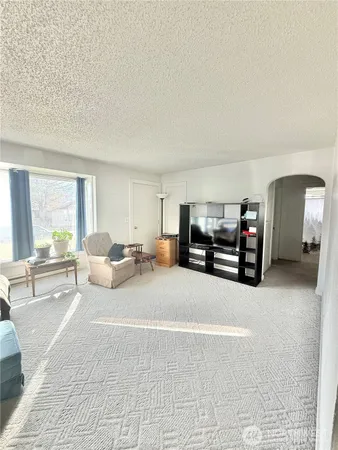 a living room with furniture window and a table