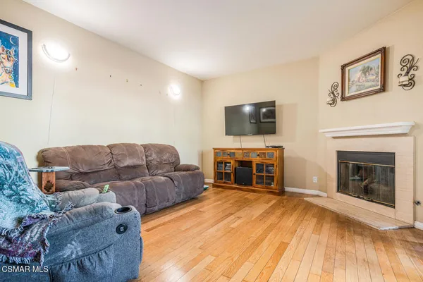 a living room with furniture a fireplace and a flat screen tv