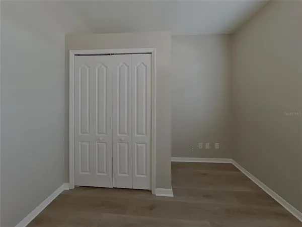 an empty room with wooden floor