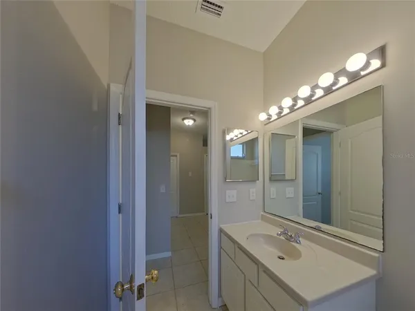 a bathroom with a sink double vanity and a mirror