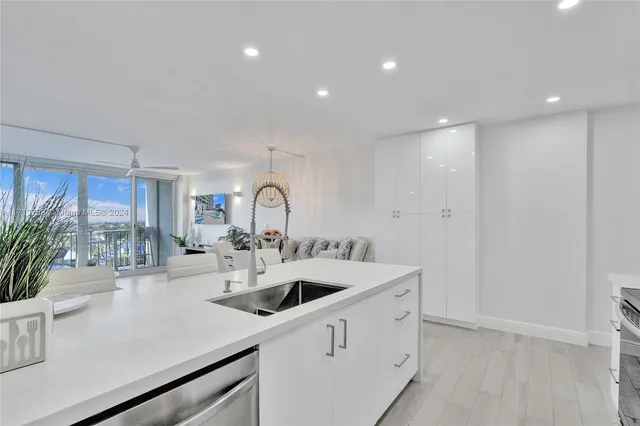 a kitchen with refrigerator and sink