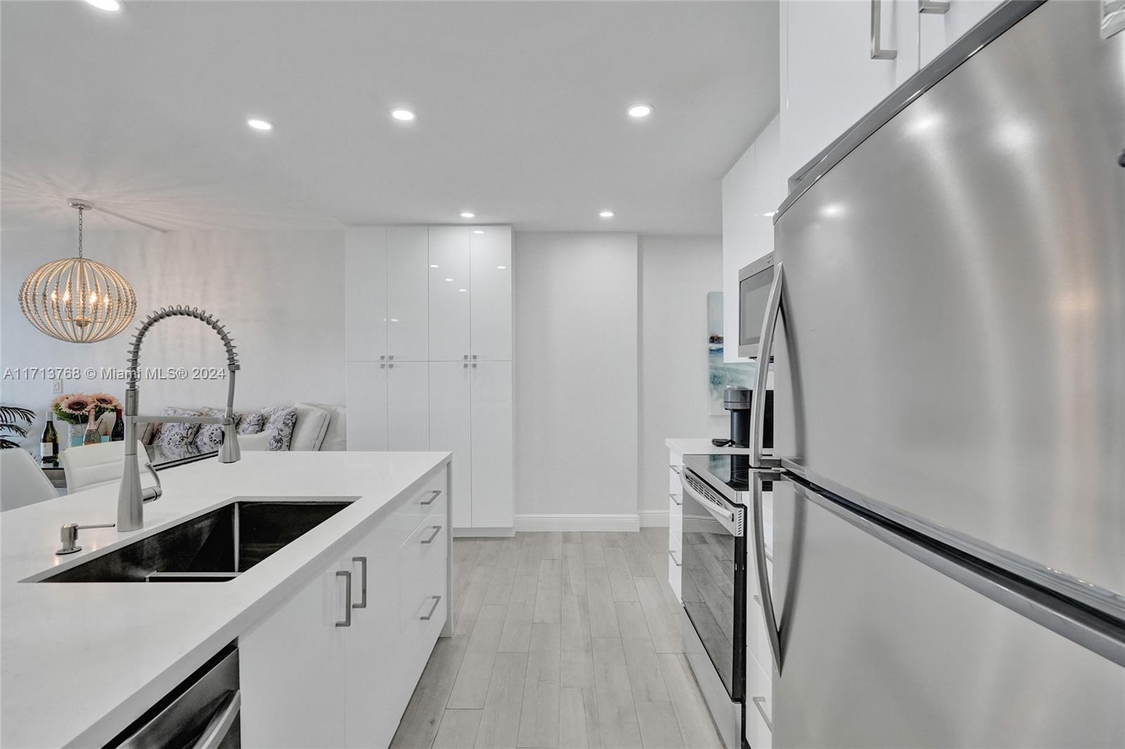 521 North Riverside Drive, Unit 705 Pompano Beach, FL 33062 - Photo 14 of 55 a kitchen with refrigerator and sink