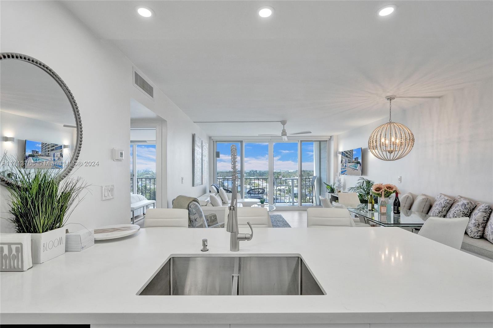 521 North Riverside Drive, Unit 705 Pompano Beach, FL 33062 - Photo 19 of 55 a view of a living room and chandelier