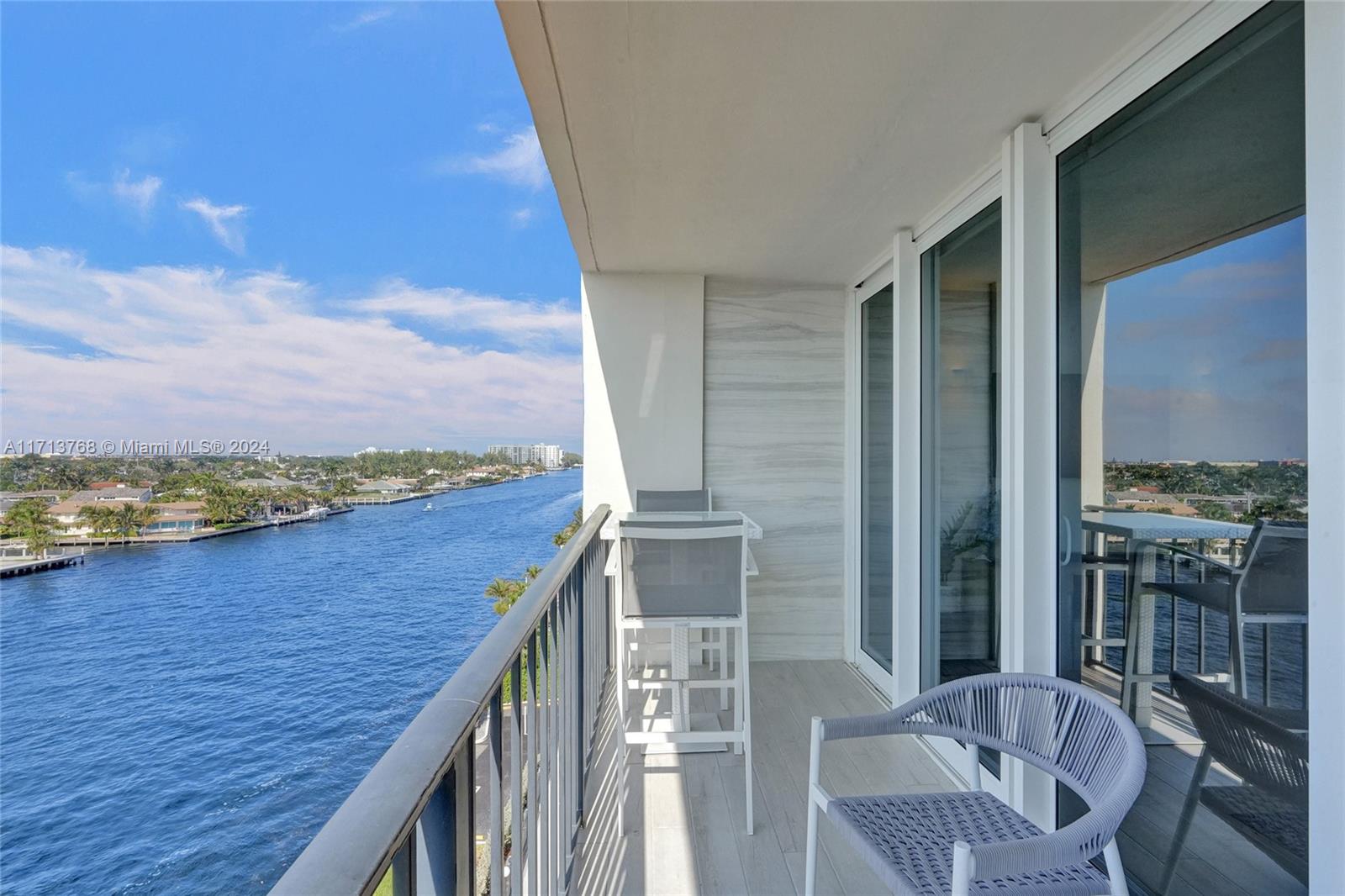 521 North Riverside Drive, Unit 705 Pompano Beach, FL 33062 - Photo 30 of 55 a view of a balcony with furniture and a floor to ceiling window