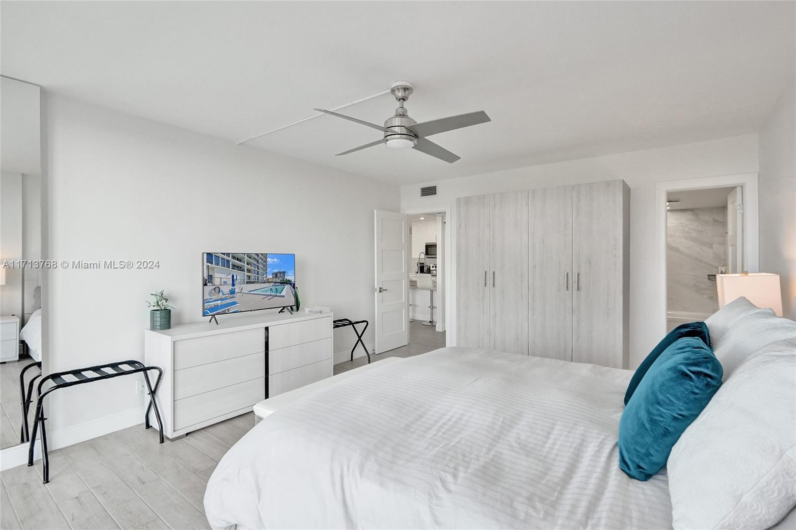 521 North Riverside Drive, Unit 705 Pompano Beach, FL 33062 - Photo 35 of 55 a bedroom with a bed and a desk