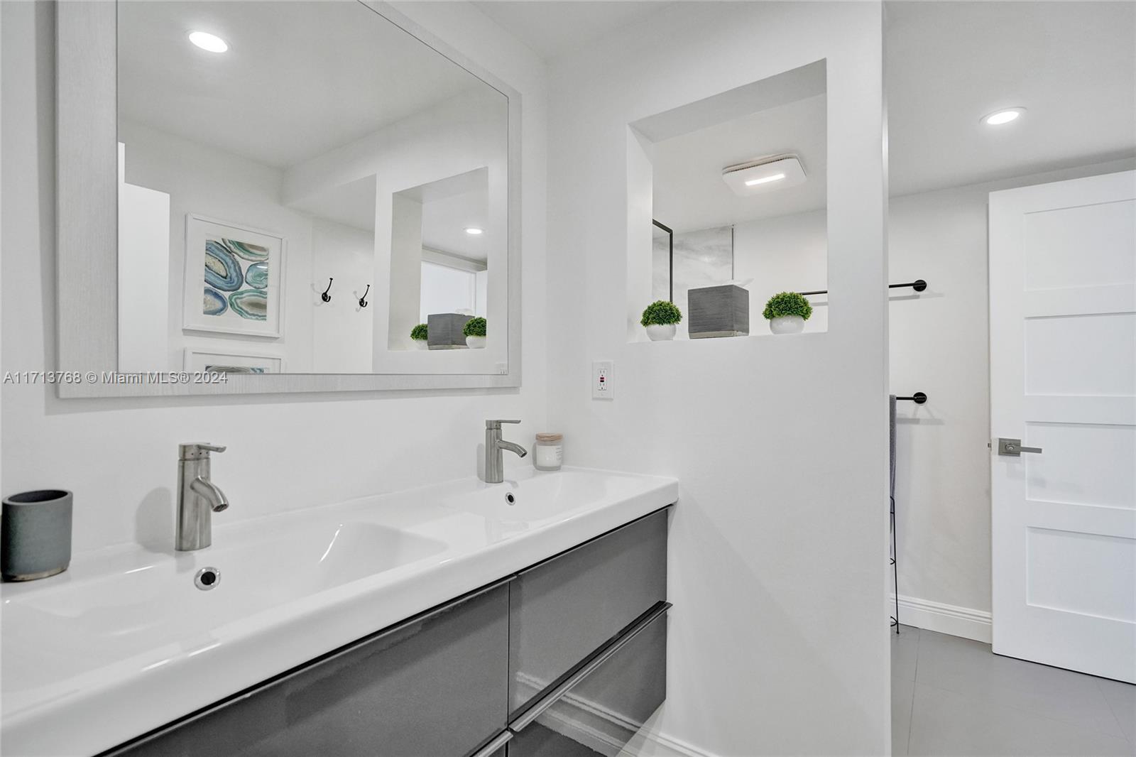 521 North Riverside Drive, Unit 705 Pompano Beach, FL 33062 - Photo 40 of 55 a bathroom with a sink and a mirror