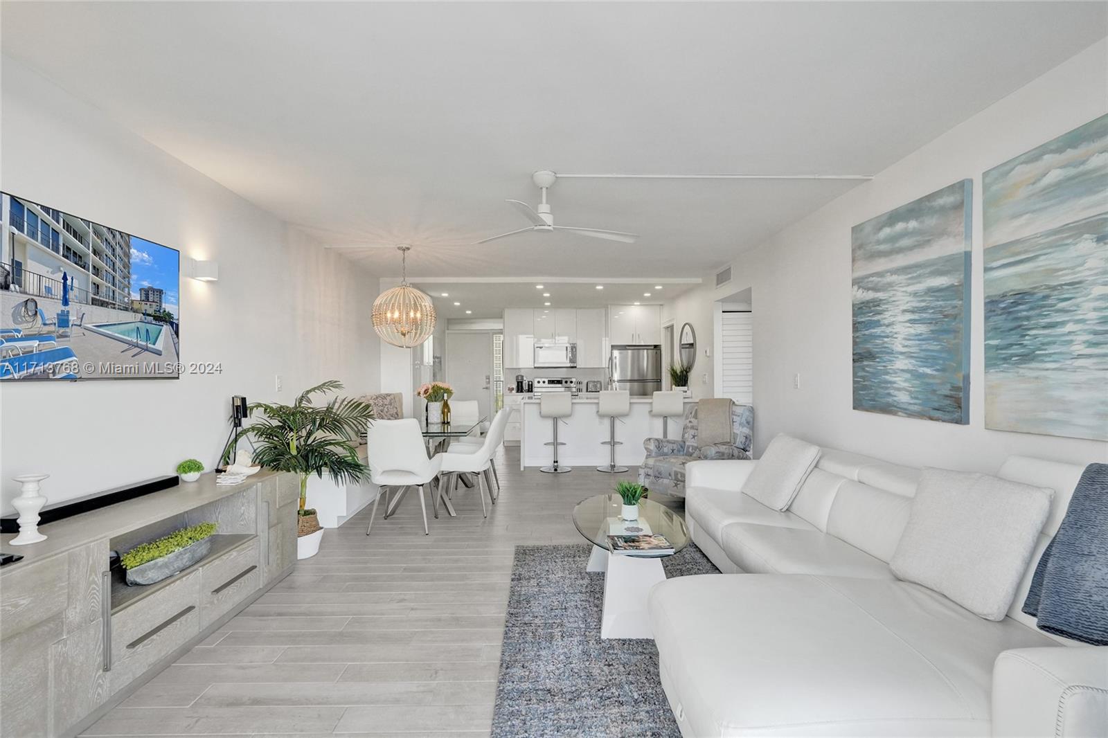 521 North Riverside Drive, Unit 705 Pompano Beach, FL 33062 - Photo 5 of 55 a living room with furniture and wooden floor