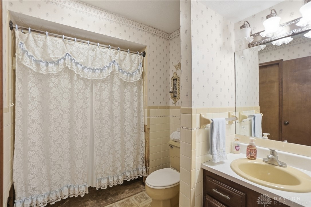 5669 O Neall Road Waynesville, OH 45068 - Photo 40 of 72 This classic bathroom features a shower, toilet, and vanity, offering functionality and charm.