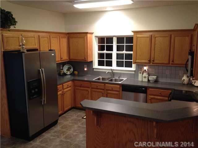 1722 Fletcher Broome Road Monroe, NC 28112 - Photo 2 of 15 a kitchen with stainless steel appliances granite countertop a sink refrigerator and cabinets