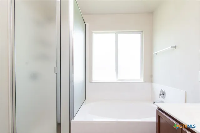 a white bath tub sitting next to a white sink