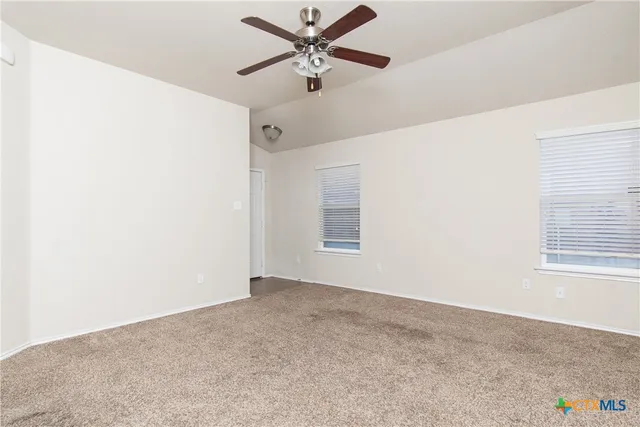 a view of a livingroom with a ceiling fan and window