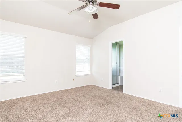 a view of a livingroom with a ceiling fan and window