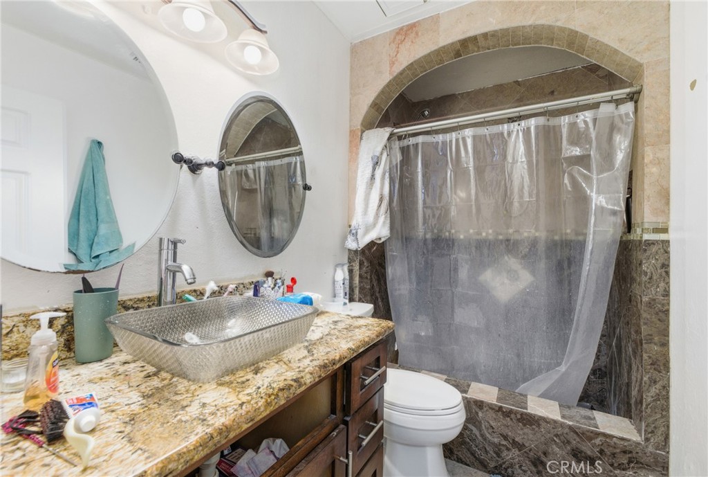 610 South Olive Avenue Rialto, CA 92376 - Photo 22 of 44 a bathroom with a sink toilet and mirror
