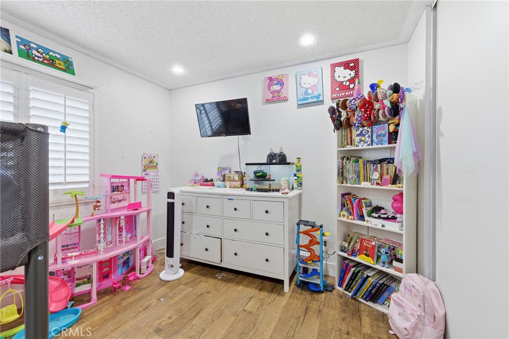 610 South Olive Avenue Rialto, CA 92376 - Photo 23 of 44 a bed room with a bed a dresser and a book shelf