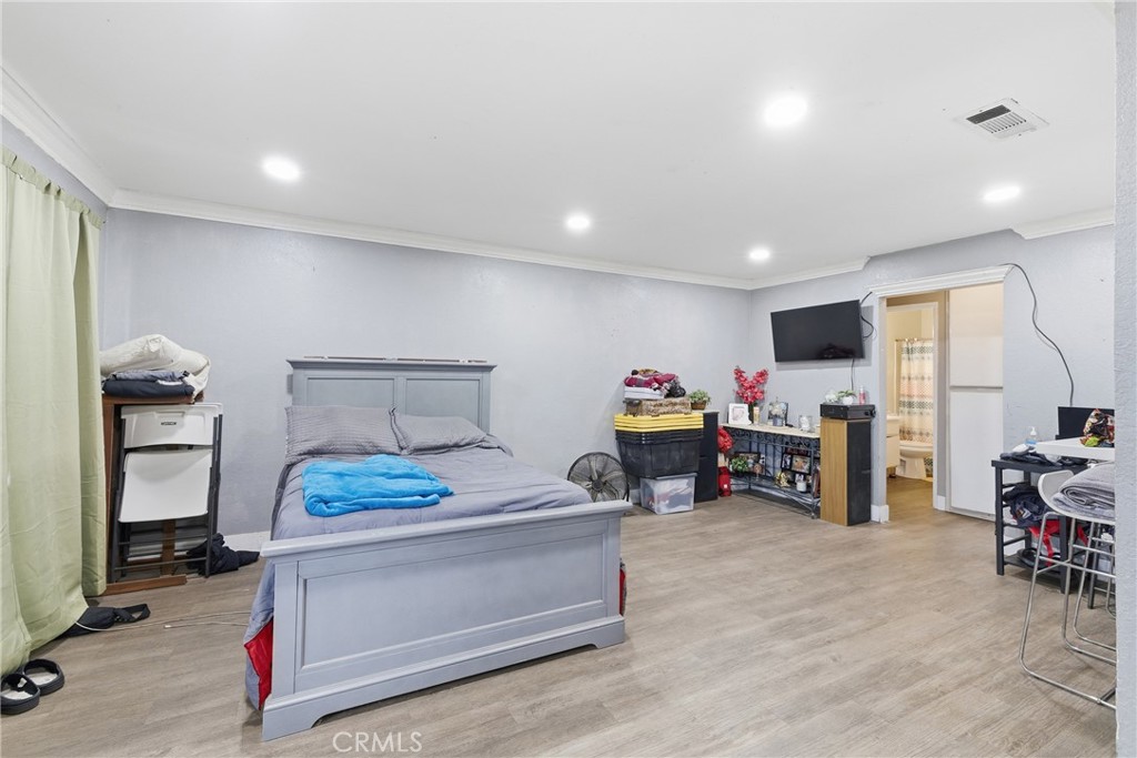 610 South Olive Avenue Rialto, CA 92376 - Photo 7 of 44 a bed room with furniture and a flat screen tv