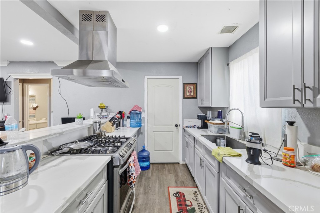 610 South Olive Avenue Rialto, CA 92376 - Photo 8 of 44 a kitchen with a sink stove and cabinets