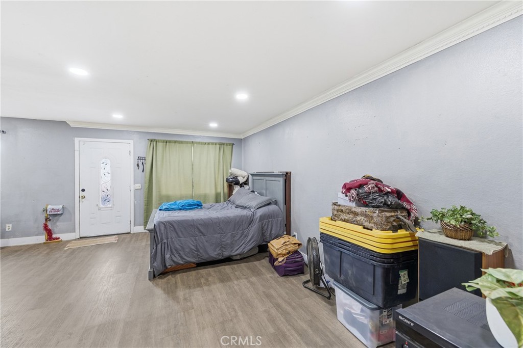 610 South Olive Avenue Rialto, CA 92376 - Photo 10 of 44 a spacious bedroom with a bed and a dresser
