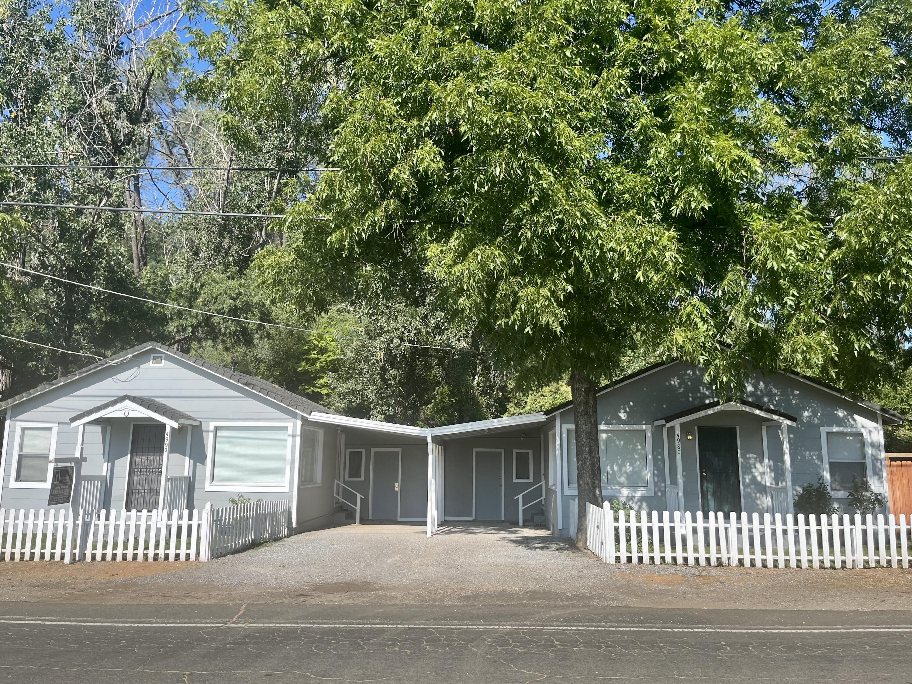 4980-4990 Cedars Road Redding, CA 96001 - Photo 1 of 67 a front view of a house with a garden