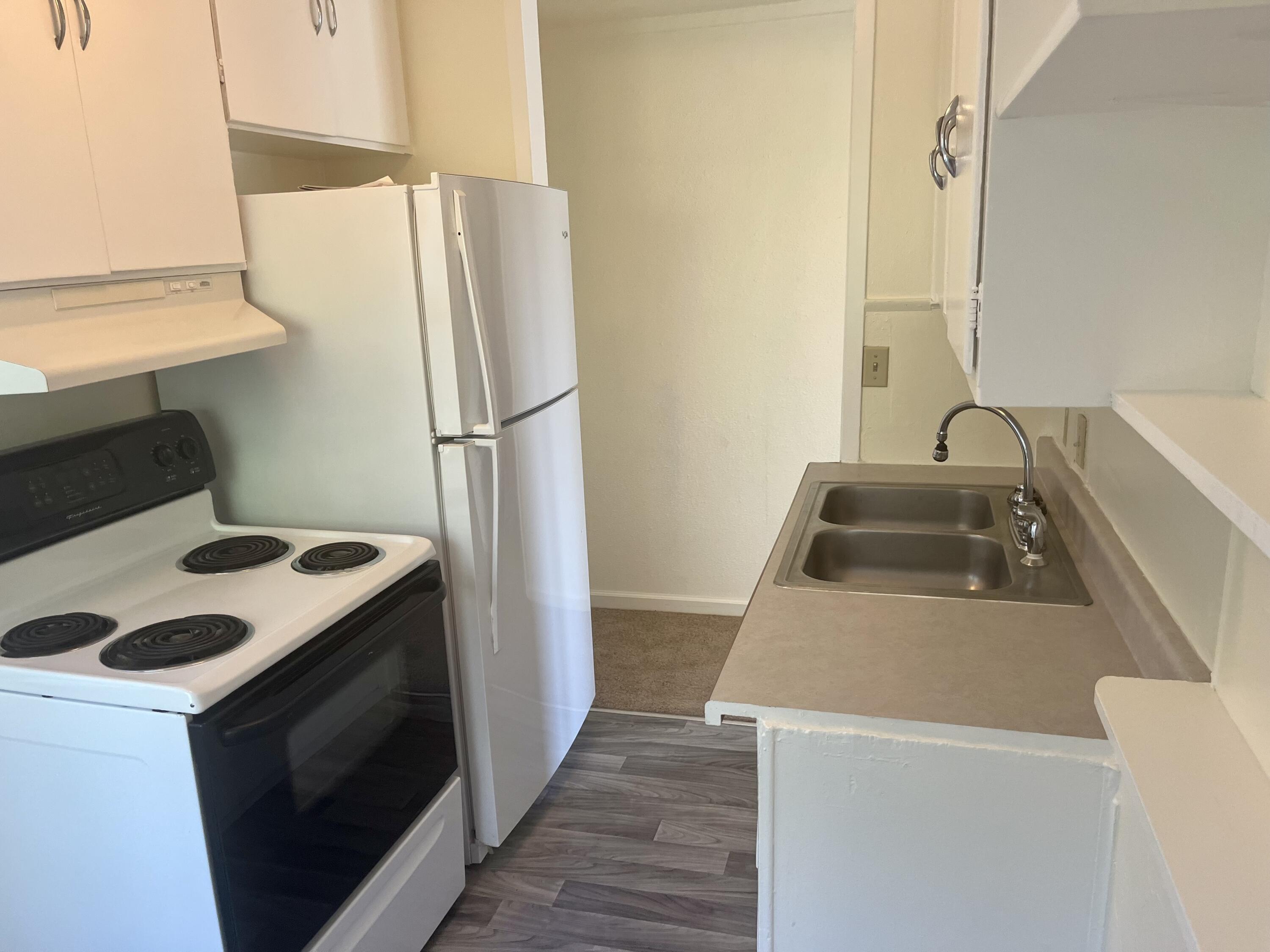 4980-4990 Cedars Road Redding, CA 96001 - Photo 15 of 67 a kitchen with a refrigerator sink and stove