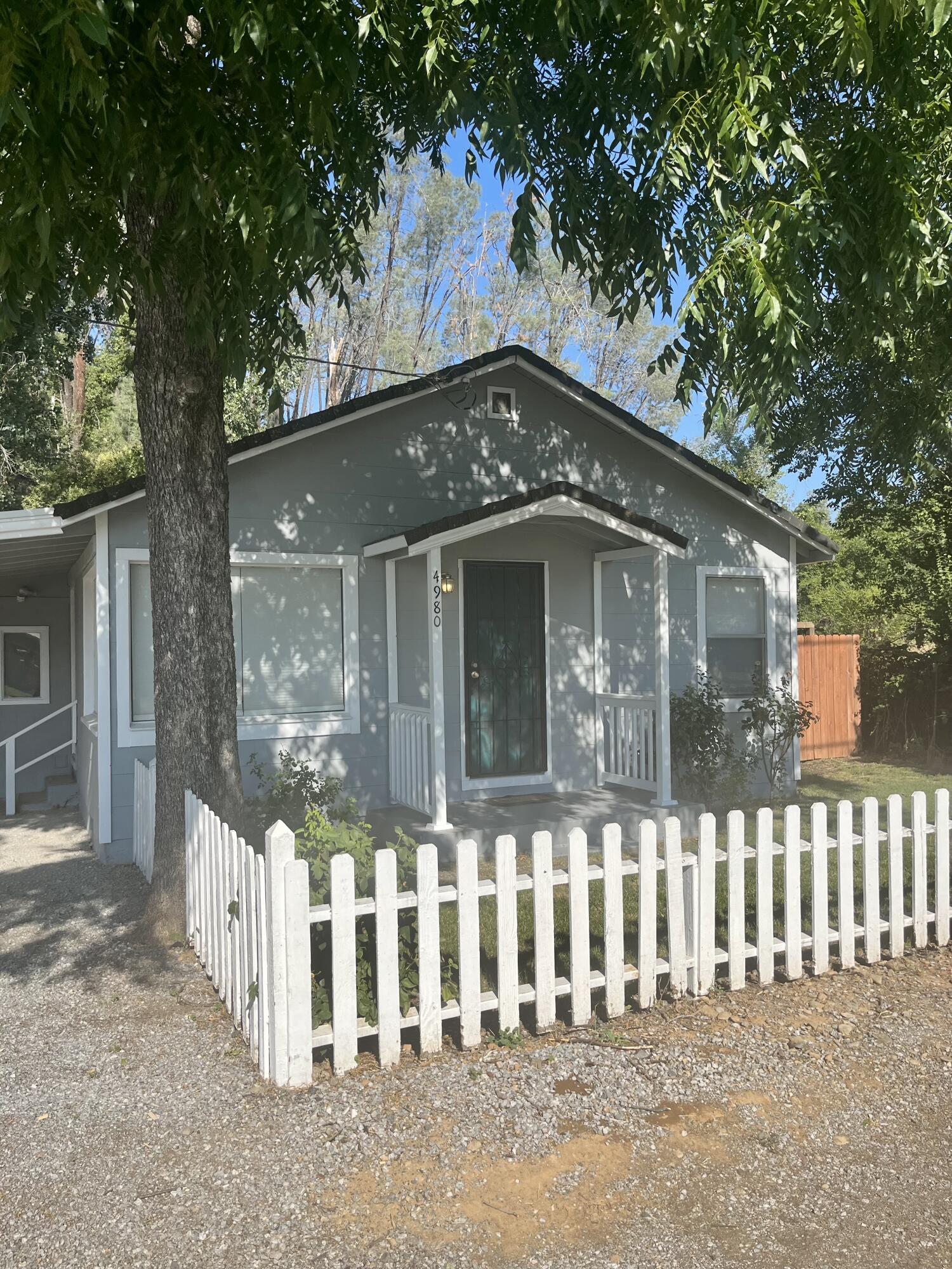 4980-4990 Cedars Road Redding, CA 96001 - Photo 3 of 67 a front view of a house with a fence