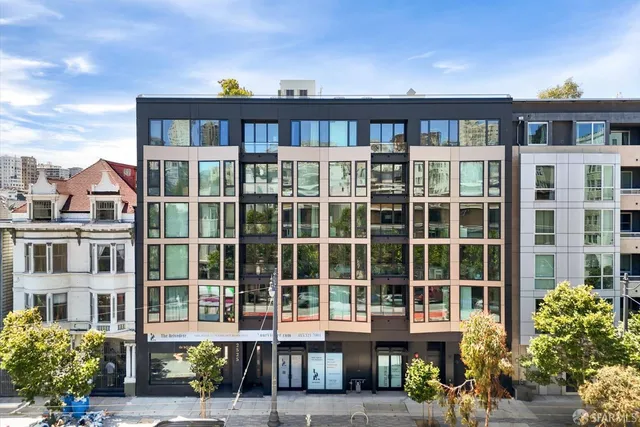 a front view of a building with a garden