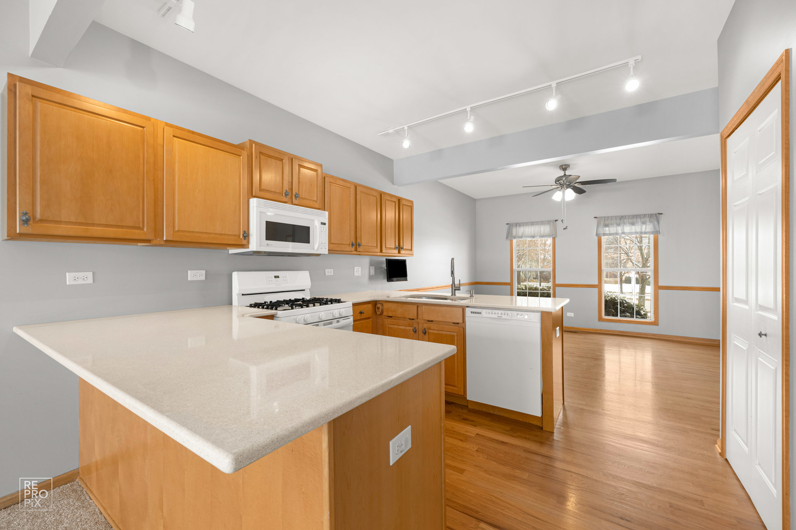 722 Ridge Drive Elburn, IL 60119 - Photo 8 of 23 a kitchen with a refrigerator a stove top oven a sink dishwasher and wooden cabinets with wooden floor