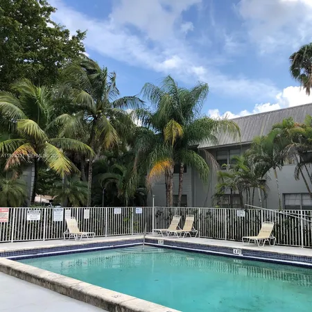 a view of a street with cars parked