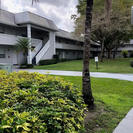 a view of a tree in front of a white house