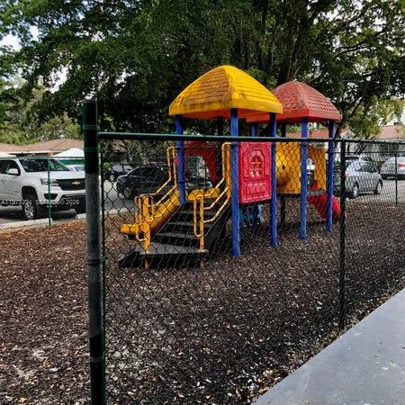 a view of a patio with table and chairs under an umbrella