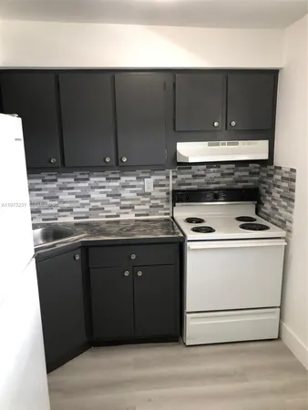 a kitchen with a stove and cabinets