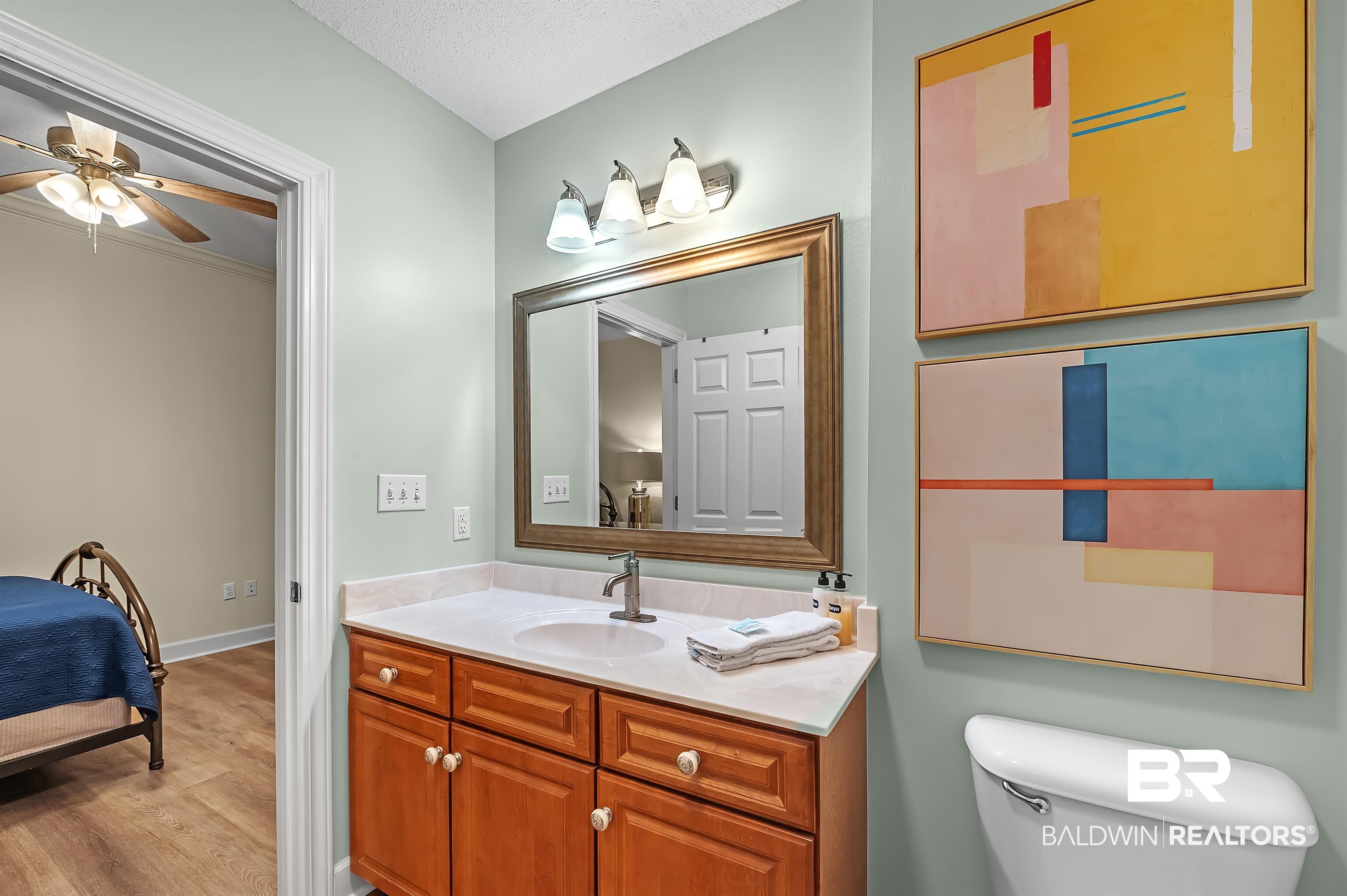 27582 Canal Road, Unit 2104 Orange Beach, AL 36561 - Photo 30 of 35 Bathroom with vanity, tub/shower combo, toilet, and hardwood / wood-style floors
