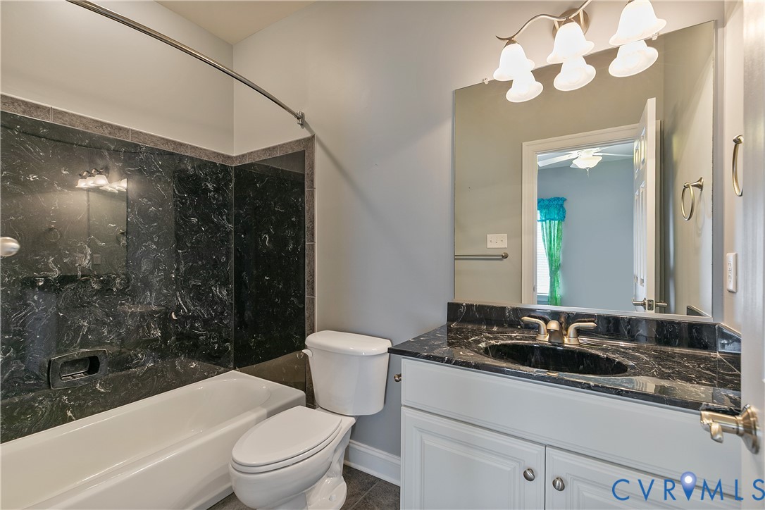 630 Cross Ridge Lane Manakin-Sabot, VA 23103 - Photo 31 of 48 a bathroom with a sink a toilet a mirror and shower