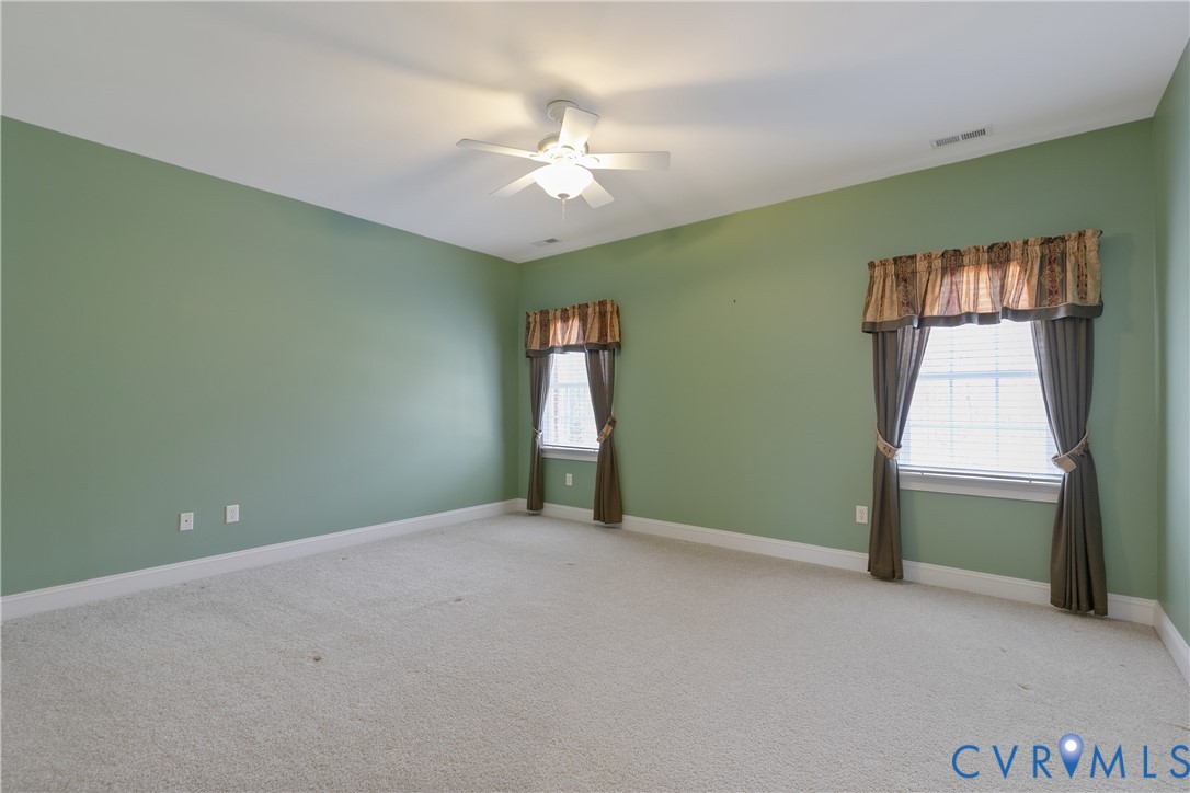 630 Cross Ridge Lane Manakin-Sabot, VA 23103 - Photo 32 of 48 an empty room with chandelier fan and windows