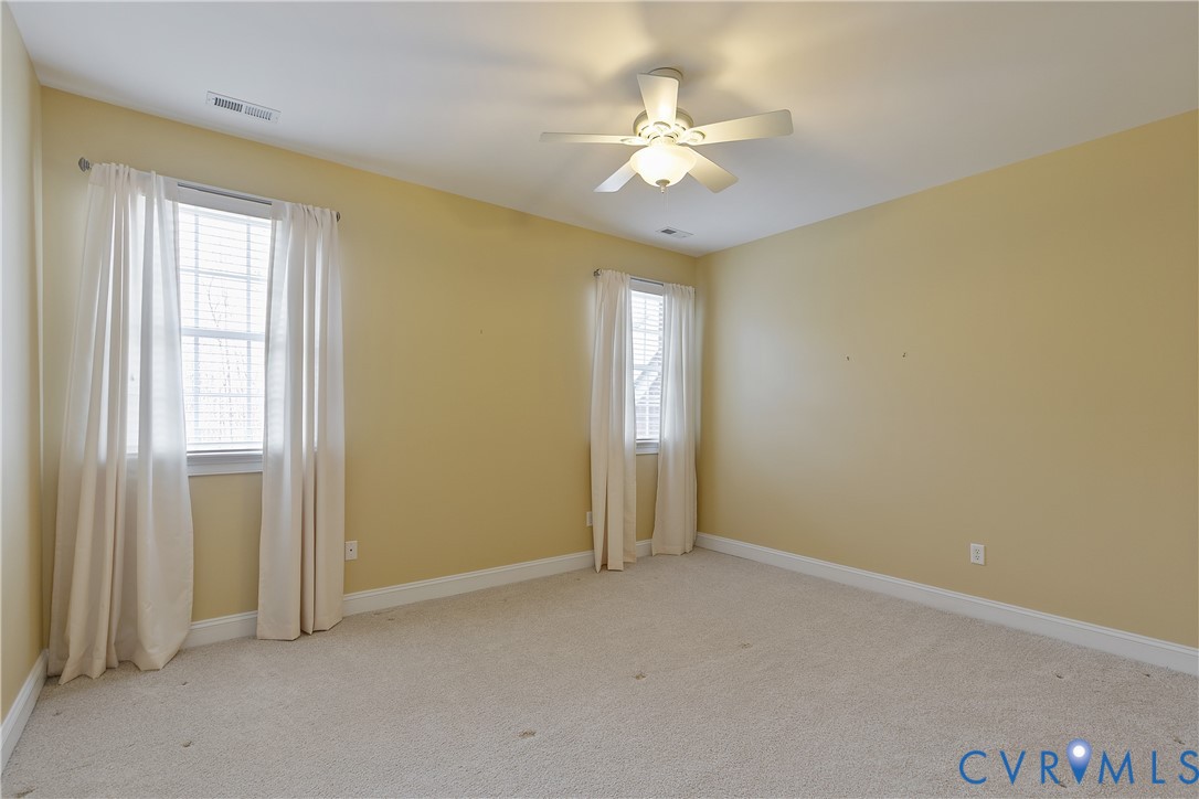 630 Cross Ridge Lane Manakin-Sabot, VA 23103 - Photo 34 of 48 an empty room with a chandelier fan and windows