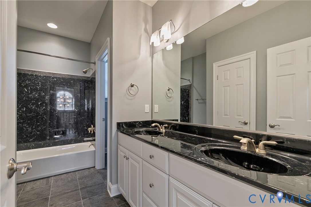 630 Cross Ridge Lane Manakin-Sabot, VA 23103 - Photo 35 of 48 a bathroom with a sink a bathtub and a mirror